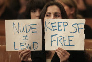 Taylor Whitfield holds up a sign protesting the Board of Supervisors proposal to ban public nakedness at City Hall in San Francisco, Tuesday, Nov. 20, 2012. San Francisco lawmakers on Tuesday narrowly approved a proposal to ban public nakedness, rejecting arguments that the measure would eat away at a reputation for tolerance enjoyed by a city known for flouting convention and flaunting its counter-culture image. The 6-5 Board of Supervisors vote means that exposed genitals will be prohibited in most public places, including streets, sidewalks and public transit. (AP Photo/Jeff Chiu)