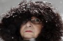 Mary Ann Bova walks along a slippery snow-covered sidewalk during a winter storm in Buffalo, N.Y., Friday, Feb. 8, 2013. In some upstate areas, snow fell early Friday morning and was expected to increase throughout the day, with the heaviest accumulations expected in eastern New York on Friday night.(AP Photo/David Duprey)