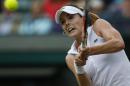 Alize Cornet of France returns a point to Serena Williams of U.S. during their women's singles match at the All England Lawn Tennis Championships in Wimbledon, London, Saturday, June 28, 2014. (AP Photo/Sang Tan)