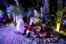 In this Friday, Dec. 20, 2013 photo, a man dressed as Santa Claus waits for guests to join him for a photograph during a Christmas party in Dubai, United Arab Emirates. The Middle East's brashest city is increasingly embracing the trappings of Christmas in a way that would be unthinkable in more conservative parts of the Muslim world. Christmas trees adorn shopping centers and residential neighborhoods, and high-end hotels try to outdo one another with extravagant and boozy holiday dinners. (AP Photo/Kamran Jebreili)