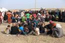 Civilians who fled their homes due to clashes gather at the Iraqi army's Camp Tariq, south Falluja