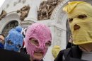 Supporters of "Pussy Riot" wear the band's trademark coloured balaclavas during a protest in Moscow