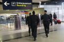 Police officers patrol at Charles de Gaulle airport, outside of Paris, Thursday, May 19, 2016. An EgyptAir flight from Paris to Cairo with 66 passengers and crew on board crashed into the Mediterranean Sea off the Greek island of Crete early Thursday morning, Egyptian and Greek officials said. (AP Photo/Christophe Ena)