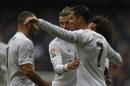 Real Madrid's Cristiano Ronaldo, right, celebrates with teammates Karim Benzema, left, and Gareth Bale after scoring against Sporting Gijon during the Spanish La Liga soccer match between Real Madrid and Sporting Gijon at the Santiago Bernabeu stadium in Madrid, Sunday, Jan. 17, 2016. Ronaldo and Benzema scored twice each and Bale scored once in Real Madrid's 5-1 victory. (AP Photo/Francisco Seco)