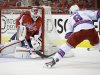 Washington Capitals goalie Braden Holtby, left, makes a save against New York Rangers right wing Darroll Powe during the second period in Game 2 of an NHL hockey Stanley Cup first-round playoff series, Saturday, May 4, 2013, in Washington. (AP Photo/Evan Vucci)