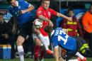 Estonia's Sergei Zenjov, left, and Martin Vunk, right, fight for the ball with England's Jack Wilshere during the Euro 2016 qualifying match between Estonia and England in Tallinn, Estonia, Sunday, Oct. 12, 2014. (AP Photo/Liis Treimann)