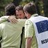 Team Europe golfer McDowell hugs McIlroy after them won their match against U.S. golfers Furyk and Snedeker on the on the 18th green during the morning foursomes round at the 39th Ryder Cup matches at the Medinah Country Club