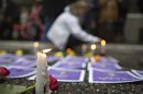 File photo of a supporter lighting candles around photos of murdered women outside Missing Women's Commission of Inquiry in Vancouver