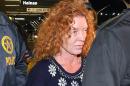 Tonya Couch, center, is taken by authorities to a waiting car after arriving at Los Angeles International Airport, Thursday, Dec. 31, 2015, in Los Angeles. Authorities said she and her son, Texas teenager Ethan Couch, who was sentenced to probation after using an "affluenza" defense for a 2013 wreck in Texas, fled to Mexico together in November as prosecutors investigated whether he had violated his probation. Both were taken into custody Monday, Dec. 28, after authorities said a phone call for pizza led to their capture in the resort city of Puerto Vallarta. (AP Photo/Mark J. Terrill)