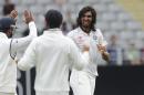 India's Ishant Sharma, right, celebrates with team mates after dismissing New Zealand's Ross Taylor for 3 in the first cricket test at Eden Park in Auckland, New Zealand, Thursday, Feb. 6, 2014. (AP Photo/SNPA, Ross Setford) NEW ZEALAND OUT