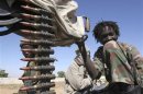 Child soldier from one of the many rebel groups operating along the Chad-Sudan border holds a gun in eastern Chad