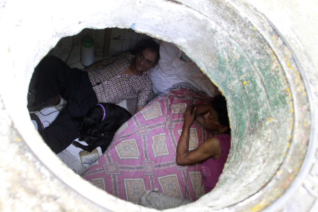 Restrepo and wife Garcia are seen from their sewer home in Medellin