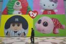 A man walks past a display for Ty Beanie Babies products at Toy Fair 2013