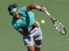 Nadal of Spain returns a volley at the net against Berdych of the Czech Republic during their men's singles semifinal match at the BNP Paribas Open ATP tennis tournament in Indian Wells