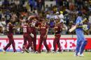West Indies fieldsman Marlon Samuels, right, is congratulated by teammates after taking a catch to dismiss India's Ravindra Jadeja, right, during their Cricket World Cup Pool B match in Perth, Australia, Friday, March 6, 2015. (AP Photo/Theron Kirkman)