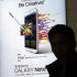 A man holds his mobile phone near an advertisement for Samsung Electronics' Galaxy Note II at Incheon International Airport in Incheon, west of Seoul, South Korea, Tuesday, Jan. 8, 2013. Samsung Electronics Co., the world's largest technology company by revenue, estimated Tuesday that its operating profit for the last quarter of 2012 nearly doubled to a record high, likely driven by continued smartphone momentum. (AP Photo/Lee Jin-man)