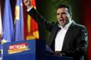 Zoran Zaev, the leader of the opposition Social-Democratic Alliance of Macedonia, raises his fist while speaking on a political gathering in Skopje, Macedonia, Tuesday, March 10, 2015. Zaev called late on Tuesday conservative Prime minister to resign over the massive wire-tapping scandal and interim cabinet to be formed that will organize free and fair elections. The text on the rostrum reads: The truth for Macedonia. (AP Photo/Boris Grdanoski)