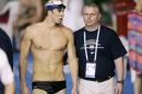 FILE - In this March 2007, file photo, U.S. swimming star Michael Phelps, left, walks with his coach Bob Bowman during a training session at the World Swimming Championships in Melbourne, Australia. Phelps is back in the U.S. drug-testing program, the strongest sign yet that he's returning for the 2016 Rio Olympics. The U.S. Anti-Doping Agency says Phelps was among the athletes who underwent doping tests in the third quarter, the period ending Sept. 30. He was tested twice. (AP Photo/Mark Baker, File)