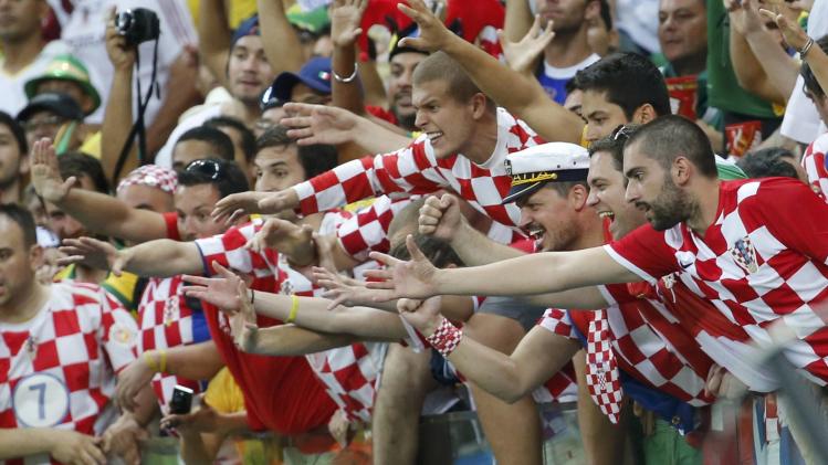 Fans of Croatia greet the team at the end of their 2014 World Cup Group A soccer match against Cameroon at the Amazonia arena in Manaus
