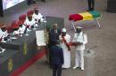 Incumbent President Alpha Conde, center, during his inauguration for a second term in Conakry, Guinea, Monday, Dec. 14, 2015, Guinea's President Alpha Conde has been sworn in for a second five-year term during a ceremony under heavy military and police supervision. Conde's second term begins weeks before the West African country hopes to mark itself free from Ebola transmission. The deadly disease killed more than 2,500 people in Guinea. (AP Photo/Youssouf Bah)