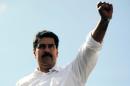 Venezuelan President Nicolas Maduro raises his fist during a rally in Caracas on November 12, 2013