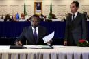 Malian Foreign Minister Abdoulaye Diop (C) signs a peace agreement as part of mediation talks between the Malian government and some northern armed groups, on March 1, 2015 in the Algerian capital Algiers