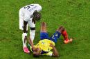 Ecuador's Osvaldo Minda, right, is attended by France's Bacary Sagna during the group E World Cup soccer match between Ecuador and France at the Maracana Stadium in Rio de Janeiro, Brazil, Wednesday, June 25, 2014. (AP Photo/Francois Xavier Marit, pool)