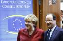 Germany's Chancellor Merkel and France's President Hollande arrive at a European Union leaders summit in Brussels