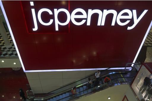 Customers ride the escalator at a J.C. Penney store in New York