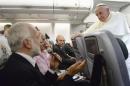 Pope Francis listens to journalist's questions as he flies back to Rome following his visit to Brazil