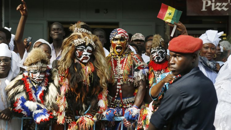Senegalese performers wait along the motorcade route as U.S. President Obama arrives to meet with Senegal's President Sall at the Presidential Palace in Dakar