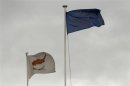 EU and Cypriot flags flutter atop the Presidential palace in Nicosia