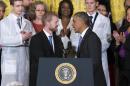 President Barack Obama shakes hands with Ebola survivor Dr. Kent Brantly during an event with American health care workers fighting the Ebola virus, Wednesday, Oct. 29, 2014, in the East Room of the White House in Washington. (AP Photo/Evan Vucci)