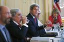 U.S. Secretary of State John Kerry, centre, meets with Iranian Foreign Minister Mohammad Javad Zarif in Vienna, Austria, Friday July 3, 2015. Iran has committed to implementing the IAEA's "additional protocol" for inspections and monitoring as part of an accord, but the rules don't guarantee international monitors can enter any facility including sensitive military sites, so making it difficult to investigate allegations of secret work on nuclear weapons. (Carlos Barria/Pool via AP)