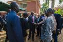 South Sudan's rebel leader Riek Machar (C) greets people as he arrives to hold a press conference in Kampala, Uganda on January 26, 2016