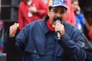 Venezuelan president Nicolas Maduro greets supporters during a march to mark International Workers' Day, in Caracas on May 1, 2016