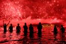 People watch fireworks during New Year's celebrations at Copacabana beach in Rio de Janeiro on January 1, 2016