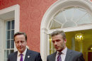 Britain's Prime Minister David Cameron, left, and David Beckham walk inside 10 Downing Street in London, ahead of a UNICEF charity meeting to discuss the issues of child hunger across the world, Thursday July 26, 2012. (AP Photo / Carl Court, Pool)