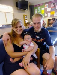 This July 16, 2012, photo shows new parents Garrett Goudeseune, 25, Laura Fritz, 27, left, with their daughter Adalade Goudeseune, as they pose for a photo at the Jefferson Action Center, an assistance center in the Denver suburb of Lakewood. Both Fritz and Goudeseune grew up in the Denver suburbs in families that were solidly middle class. But the couple has struggled to find work and are now relying on government assistance to cover food and $650 rent for their family. The ranks of America's poor are on track to climb to levels unseen in nearly half a century, erasing gains from the war on poverty in the 1960s amid a weak economy and fraying government safety net. Census figures for 2011 will be released this fall in the critical weeks ahead of the November elections. (AP Photo/Kristen Wyatt)