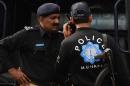 Pakistan police use their communication radio in Lahore on March 19, 2012