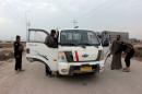 Iraqi security forces search vehicles in Basra province