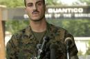 U.S. Marine Corps Corporal Wassef Ali Hassoun reads a prepared statement outside the gate at Quantic..