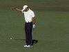 Tiger Woods takes a drop on the 15th hole after his ball went into the water during the second round of the Masters golf tournament Friday, April 12, 2013, in Augusta, Ga. The drop is being reviewed by the rules committee. (AP Photo/Charlie Riedel)