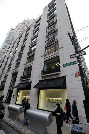 Pedestrians pass Barneys New York department store …