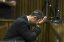 With a bucket on the floor nearby, Oscar Pistorius covers his face with his hands as he listens to cross questioning about the events surrounding the shooting death of his girlfriend Reeva Steenkamp, in court during his trial in Pretoria, South Africa, Tuesday, March 11, 2014. Pistorius is charged with the shooting death of Steenkamp, on Valentines Day in 2013. (AP Photo/Kevin Sutherland, Pool)