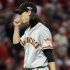 San Francisco Giants relief pitcher Tim Lincecum blows on his hands in the eighth inning of Game 4 of the National League division baseball series against the Cincinnati Reds, Wednesday, Oct. 10, 2012, in Cincinnati. Lincecum was the winning pitcher in the game won by the Giants 8-3. (AP Photo/Michael Keating)