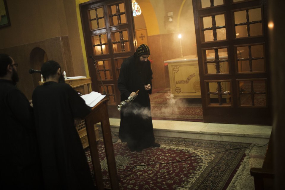 A priest purifies the church with incense during prayer at Al-Mahraq monastery in Assiut, Upper Egypt, Tuesday, Aug. 6, 2013. Islamists may be on the defensive in Cairo, but in Egypt's deep south they still have much sway and audacity: over the past week, they have stepped up a hate campaign against the area's Christians. Blaming the broader Coptic community for the July 3, 2013 coup that removed Islamist President Mohammed Morsi, Islamists have marked Christian homes, stores and churches with crosses and threatening graffiti. (AP Photo/Manu Brabo)