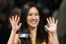 FILE - In this Jan. 28, 2012 file photo, former figure skater Michelle Kwan waves at an on-ice recognition for her Hall of Fame induction at the U.S. Figure Skating Championships in San Jose, Calif. Kwan is fitting in some time for political campaigning while she covers the Sochi Games. The two-time Olympic figure skating medalist is asking notable names to pose for a photo holding a pin supporting Clay Pell for governor of Rhode Island. Her husband announced Jan. 27, 2014, that he is running for the state's top office. (AP Photo/Jeff Chiu, File)