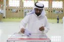 A voter casts his ballot during elections in District 3 Khaldeya