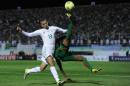Islam Slimani (L) of Algeria and Benjamin Balima (R) of Burkina Faso vie for the ball during their World Cup qualifying match on November 19, 2013 in Blida, Algeria